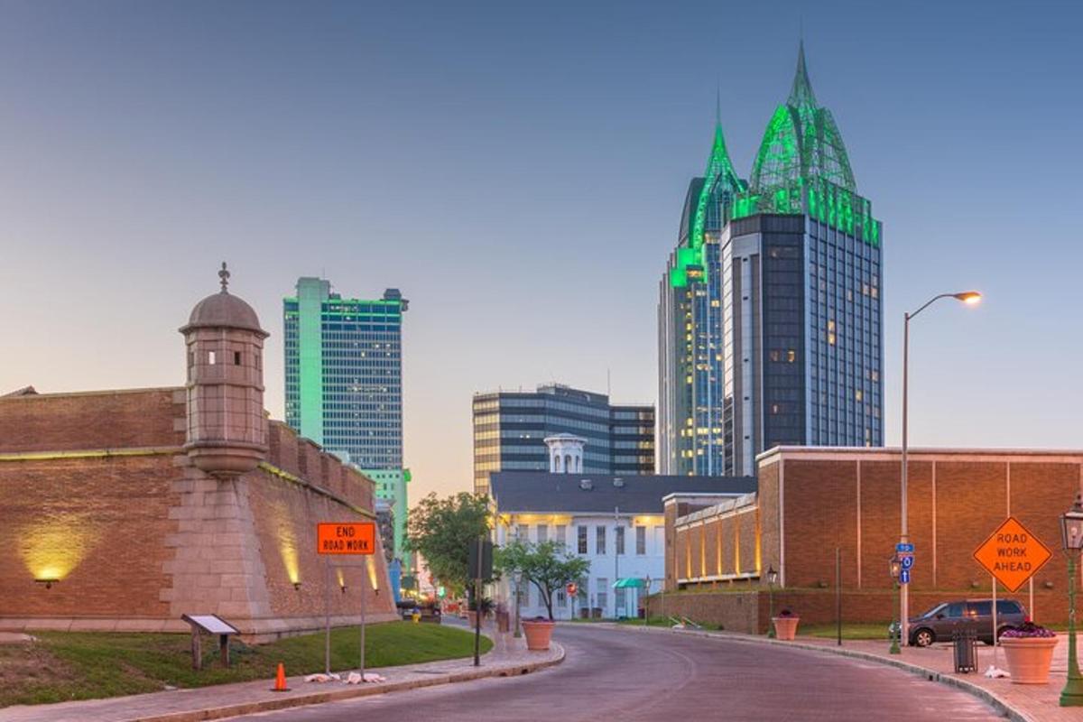 a city street with tall buildings in the background