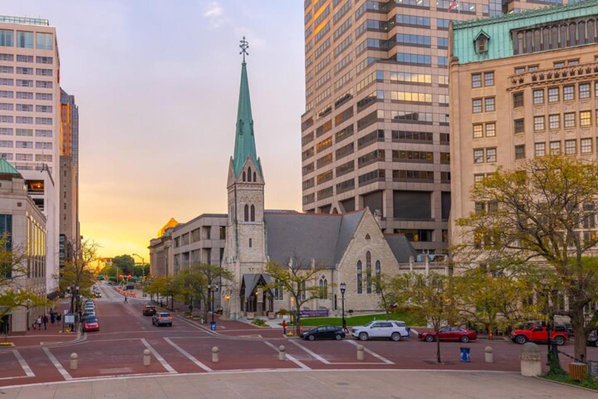 a church with a steeple in the middle of a city