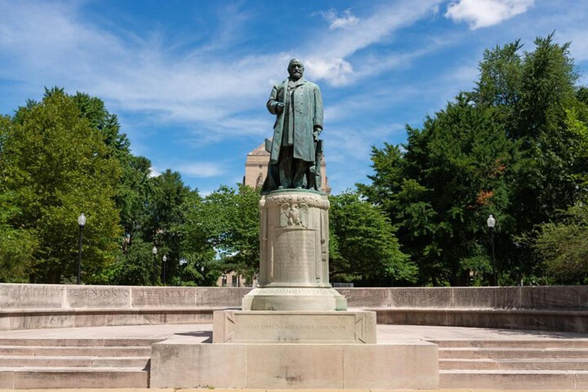 a statue of a man standing on top of stairs