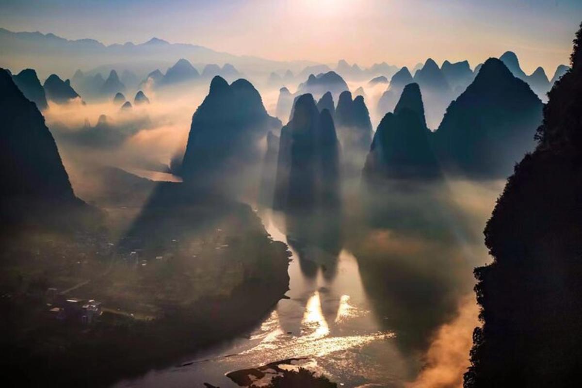 a view of a river with mountains in the background