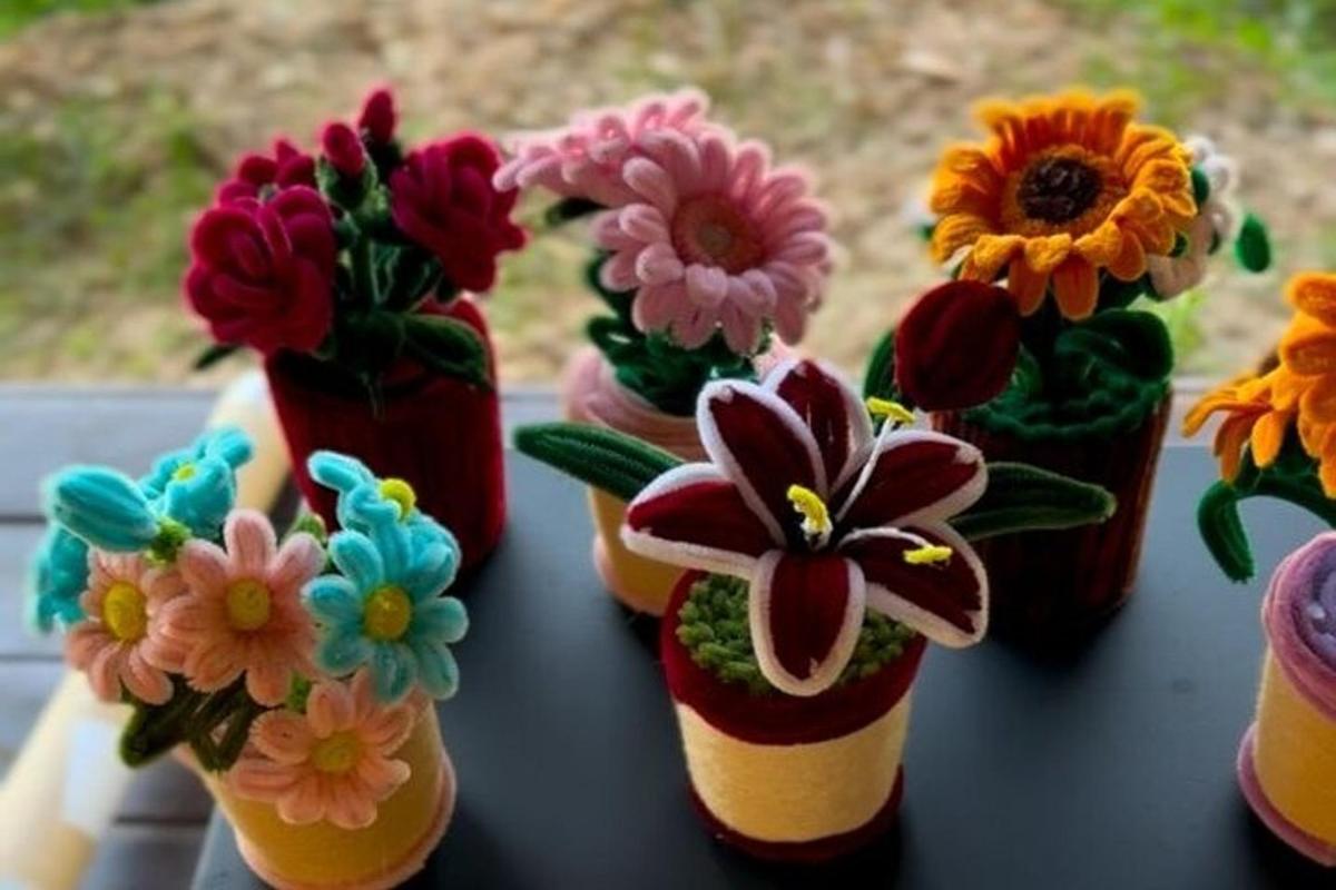 a group of flower vases with flowers in them