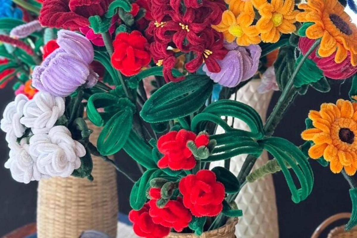 two vases filled with colorful flowers on a table