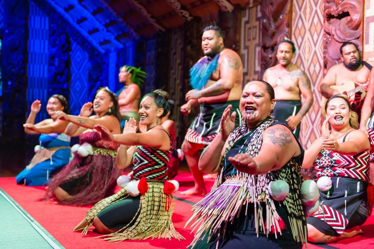 a group of people singing and dancing on a stage