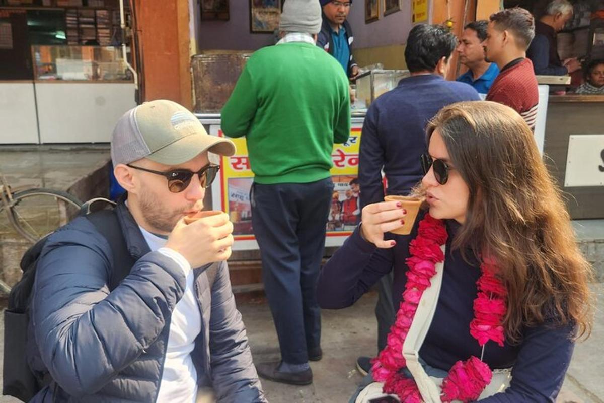 a man and a woman sitting down eating food