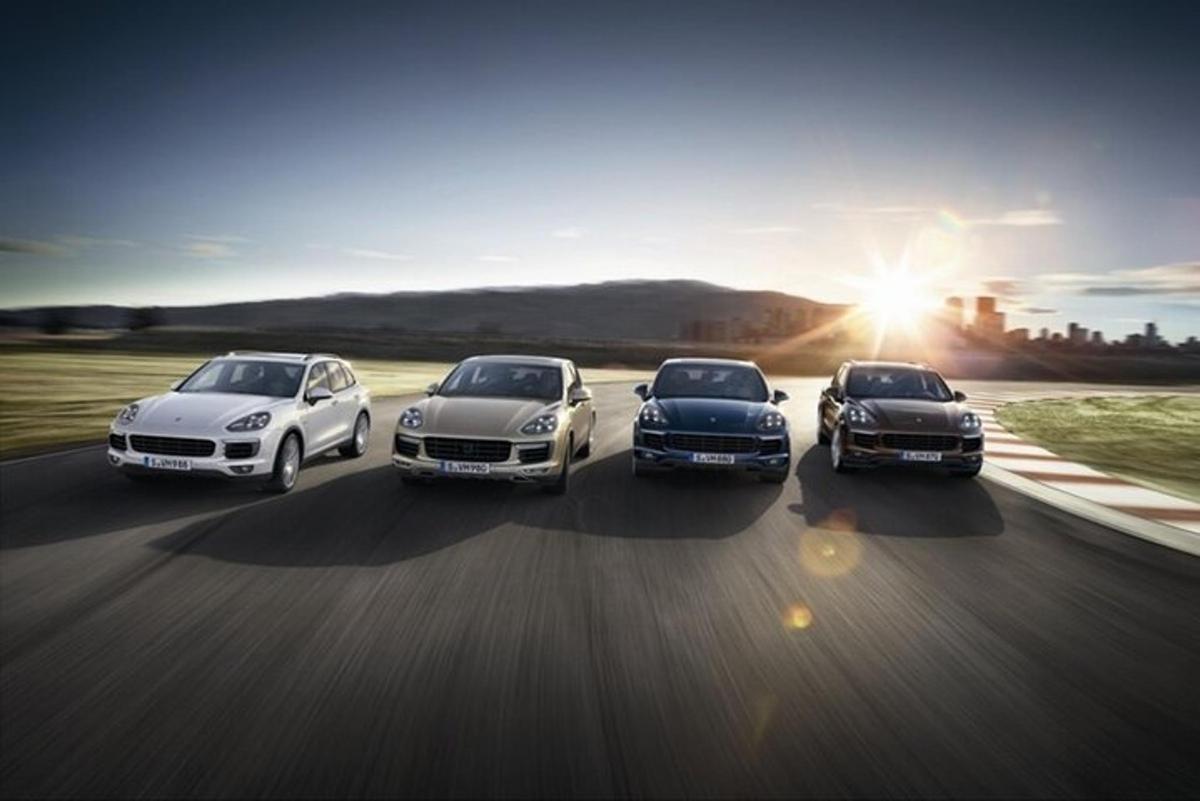 a group of four cars driving down a road