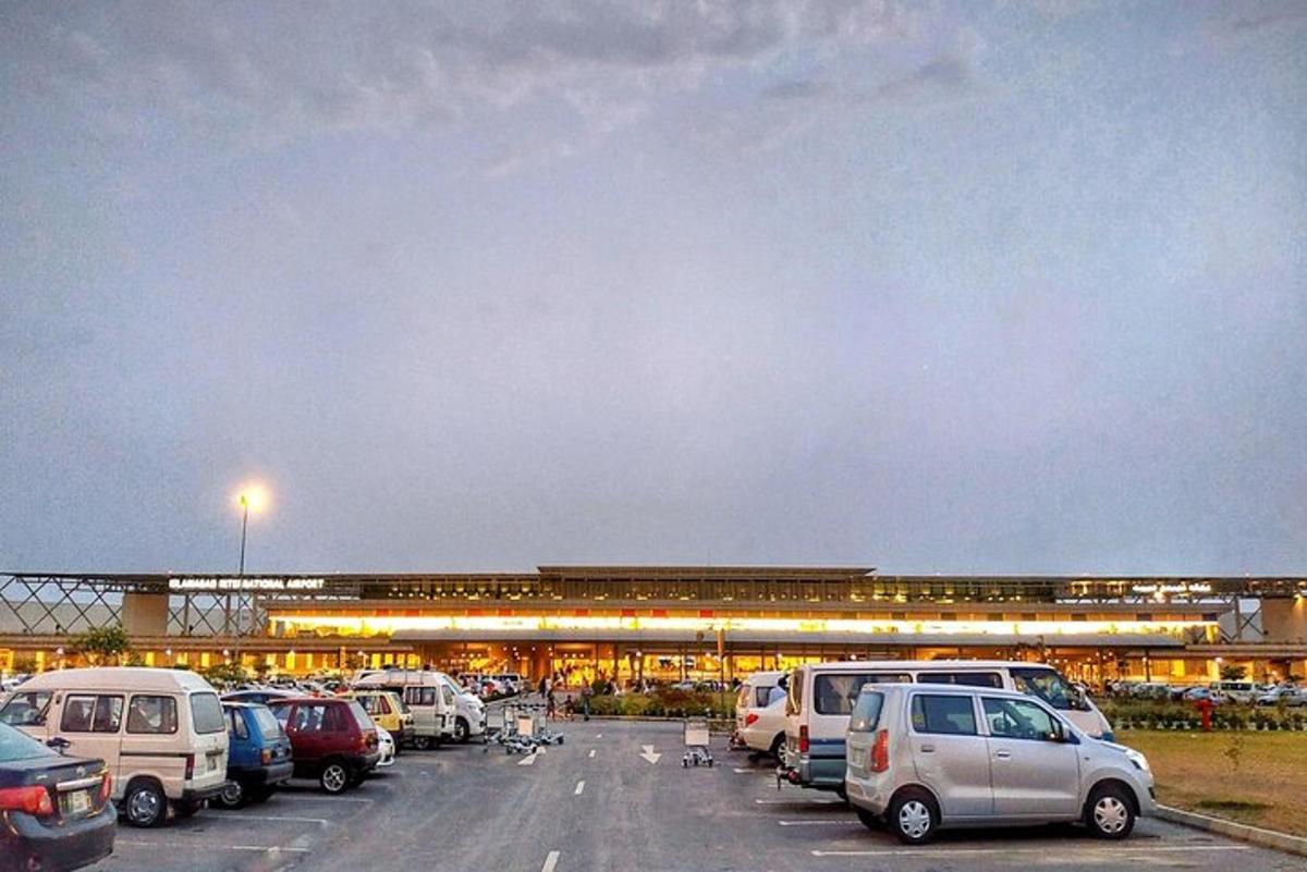 a parking lot with cars parked in front of an airport