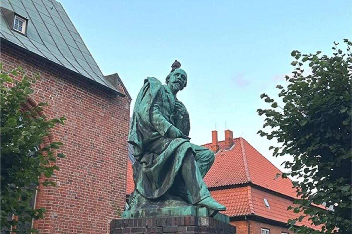a statue of a woman standing in front of a brick building