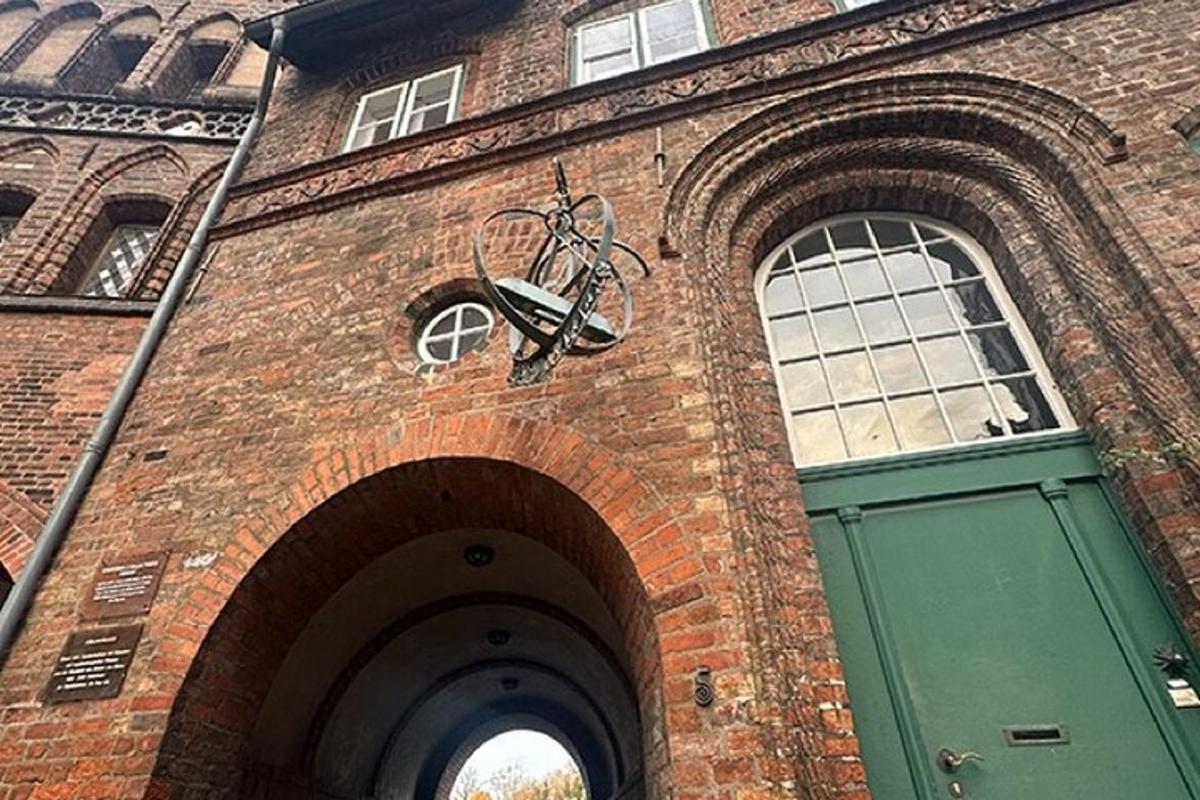 a brick building with a green door with a bike on it