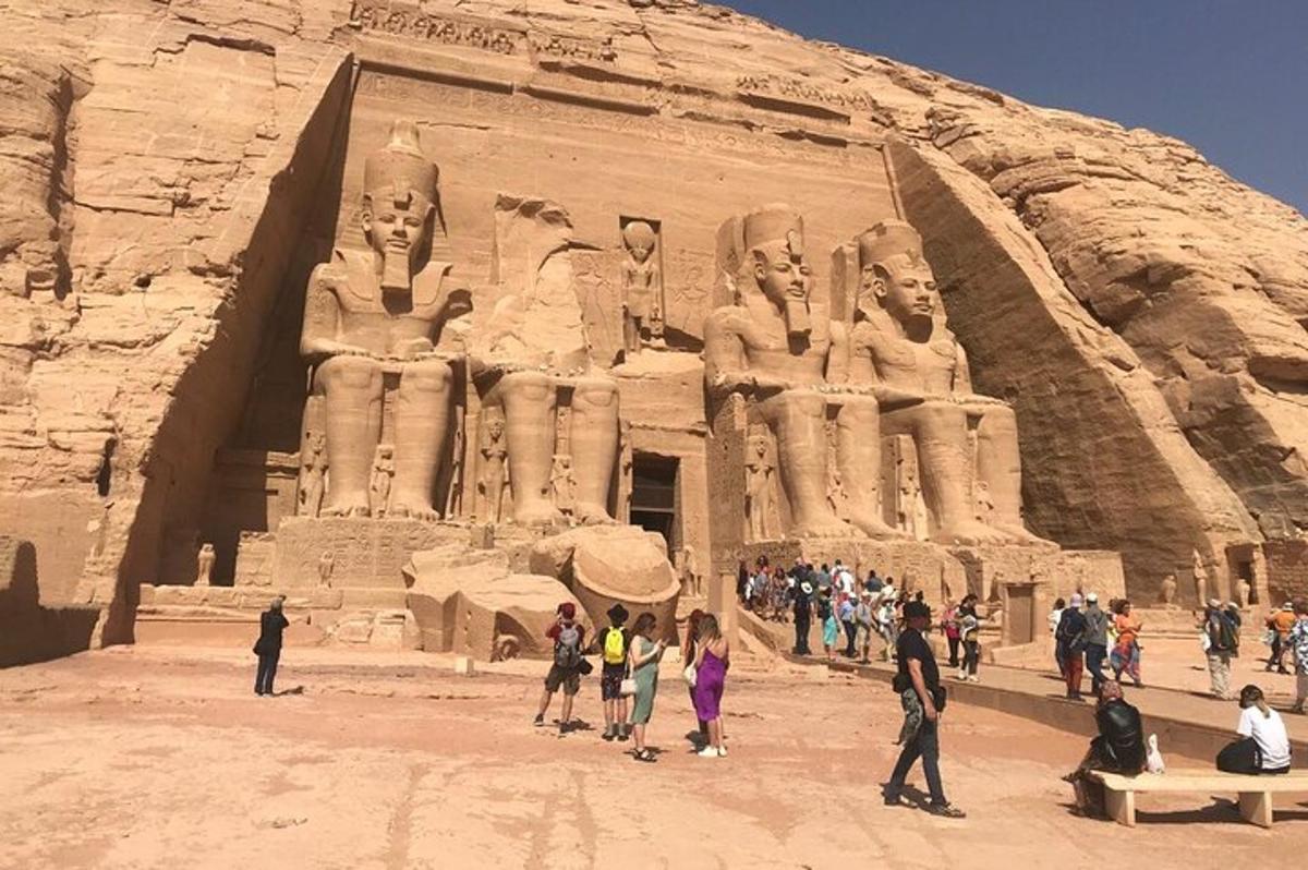 a group of people standing in front of a statue