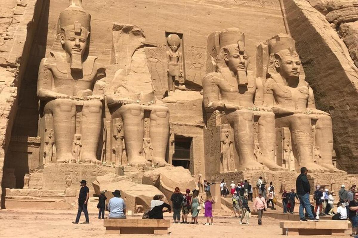 a group of people standing in front of a large statue
