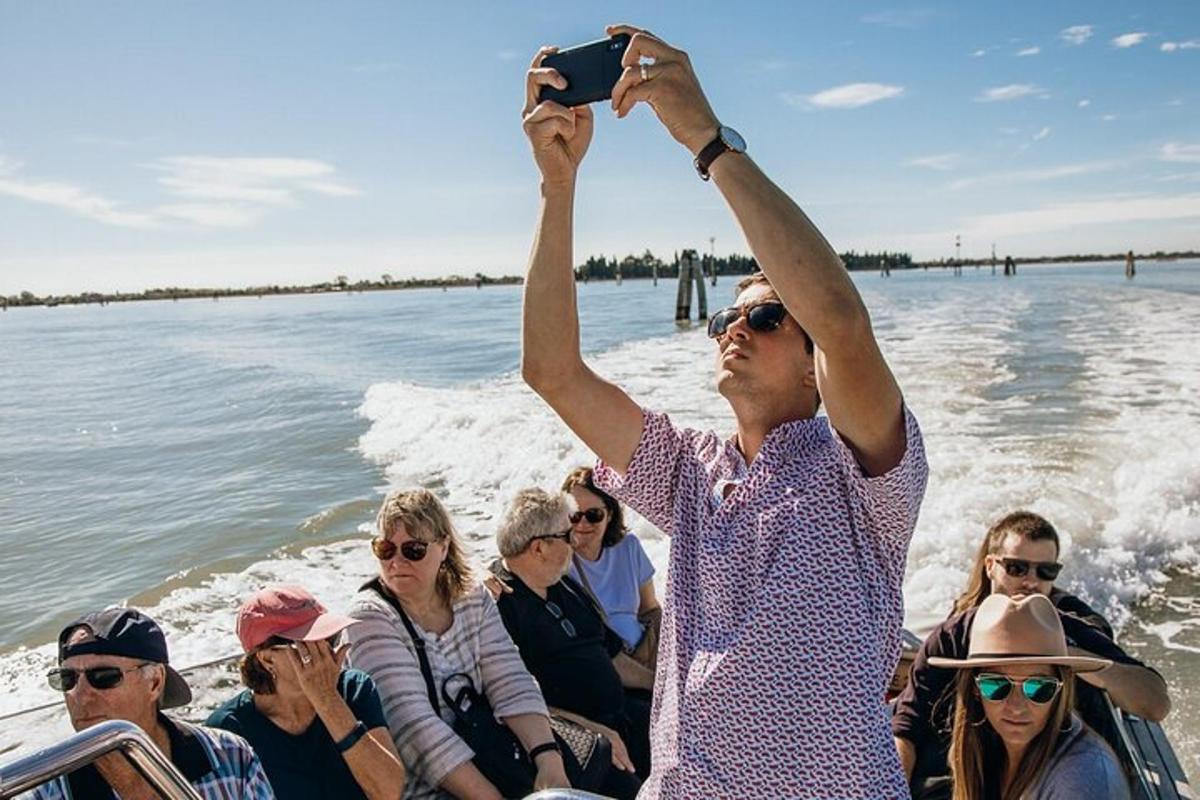 a woman taking a picture of a group of people on a boat