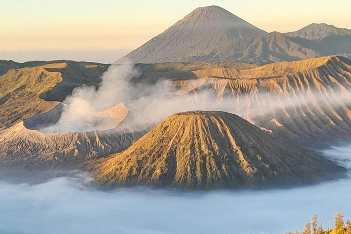 a mountain in the sky with a fog on it
