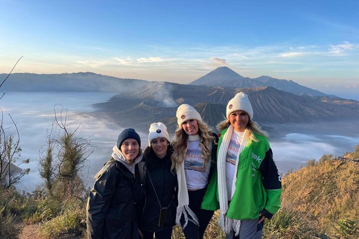 a group of people standing on top of a mountain