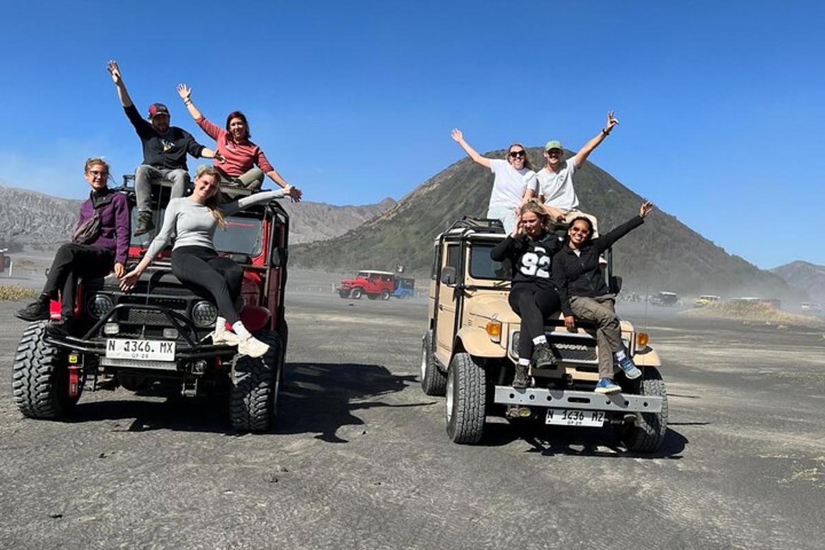 a group of people sitting on the back of atvs in the desert