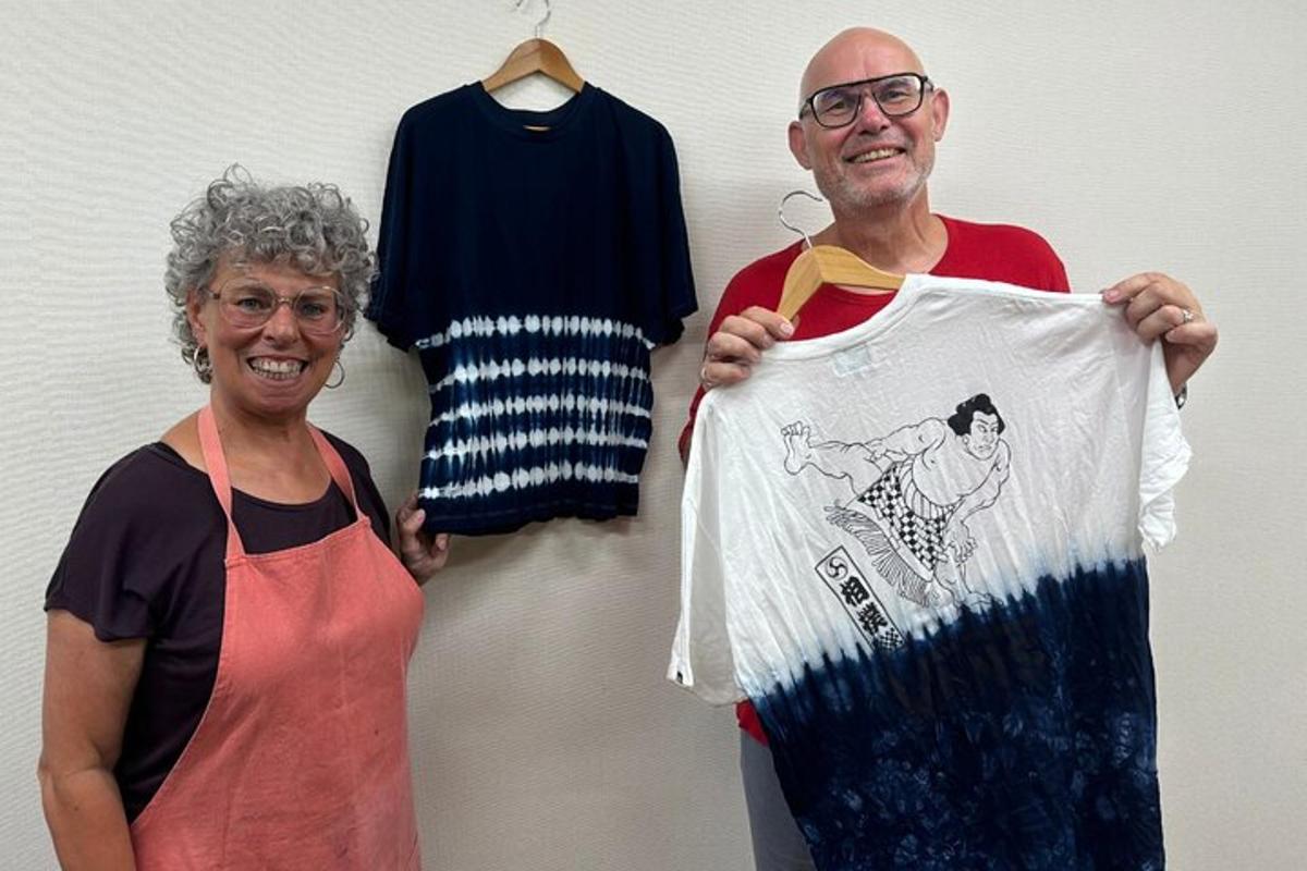 a man and a woman holding a t shirt and a shirt