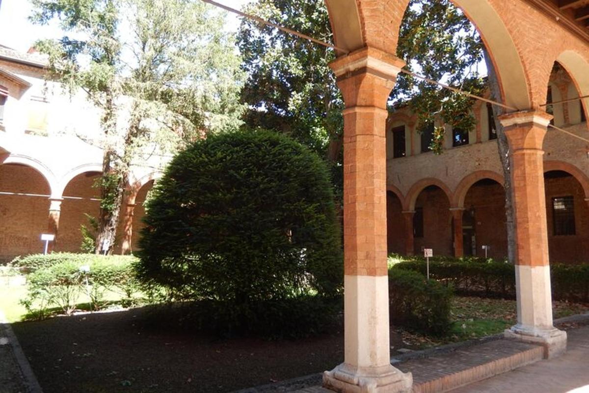 a building with a brick pillar and a bush