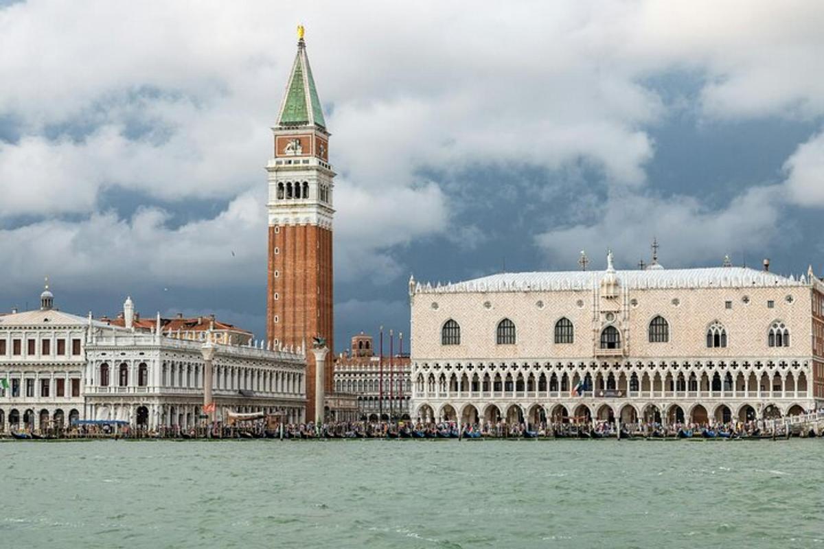 a large building with a clock tower next to the water