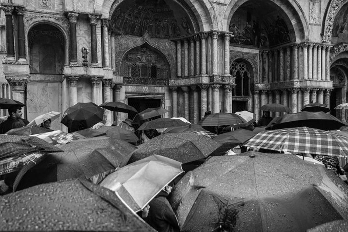 a group of people with umbrellas in a building