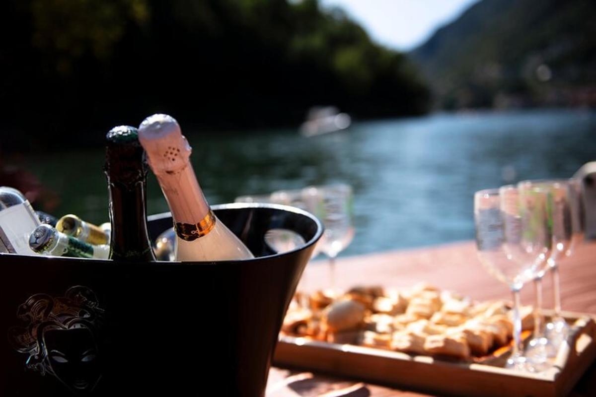 a table with a bottle of champagne and a plate of food