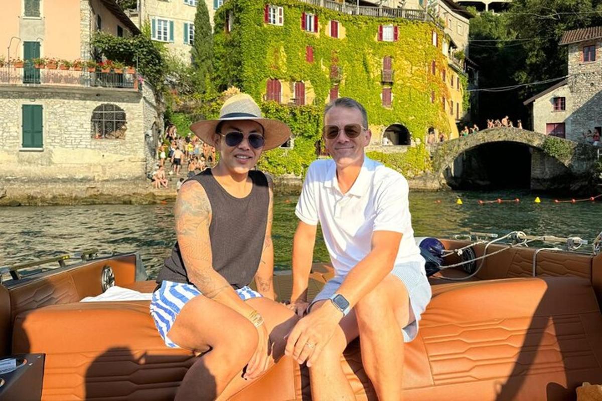 a man and woman sitting on a boat on the water