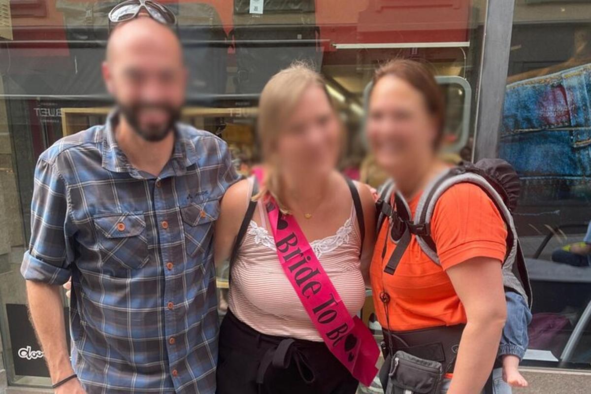 a man and two women standing in front of a store