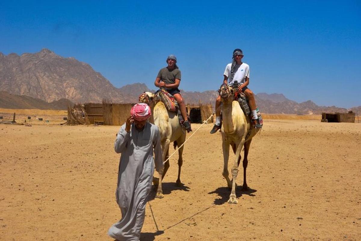 two men riding on horses in the desert