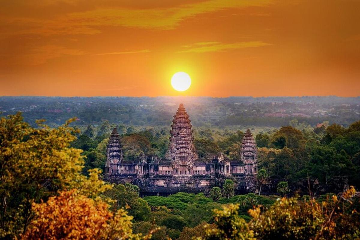 a sunset over the temples of angkor wat
