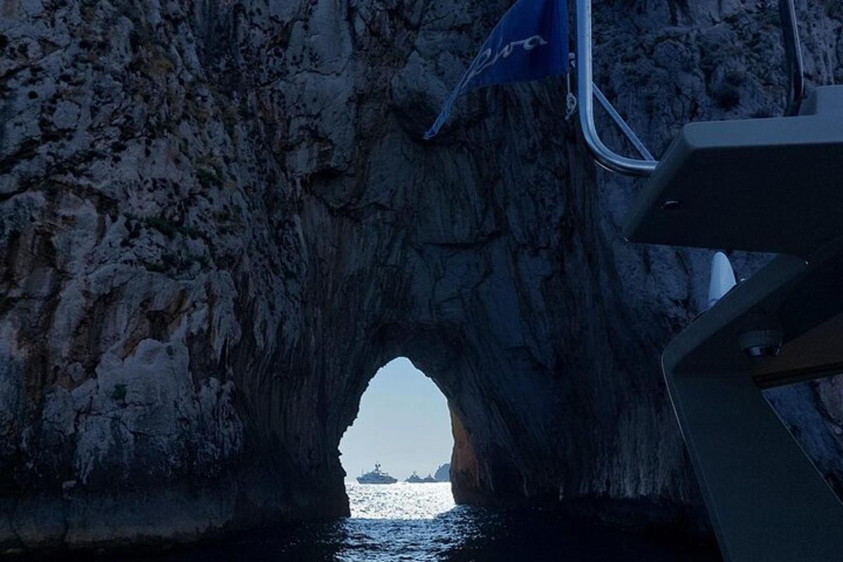 an entrance to a cave in a rock formation in the water