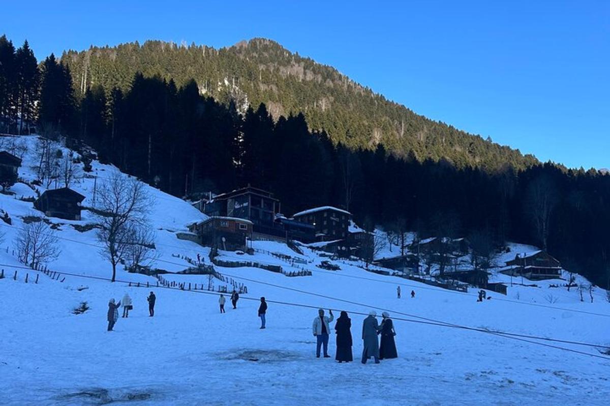 a group of people standing on a snow covered slope