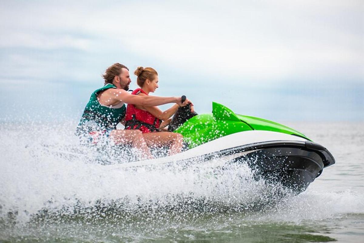 two people riding on a jet ski in the water