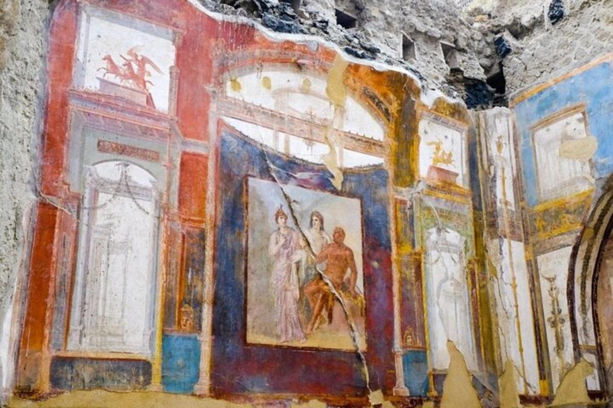 a room with paintings on the walls of a building