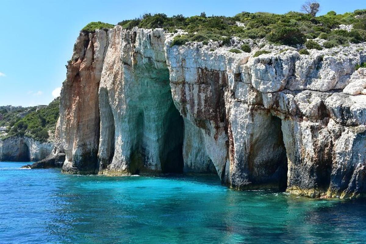 a large cliff in the water next to the ocean