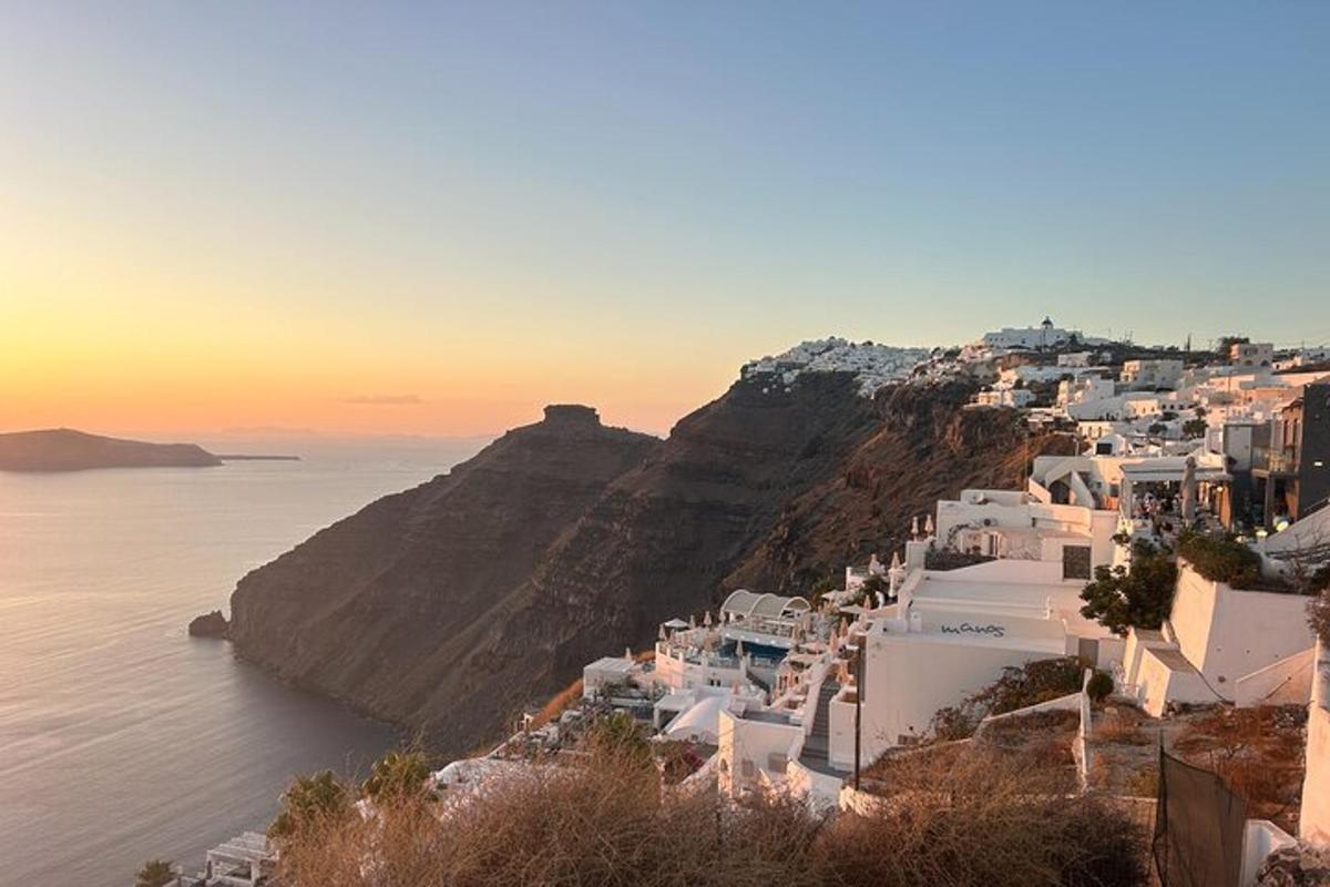a view of a town on a hill with the ocean