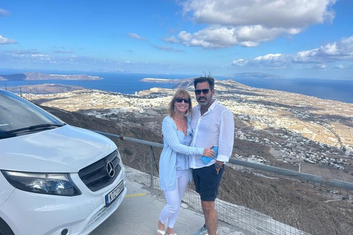 a man and a woman standing next to a white car