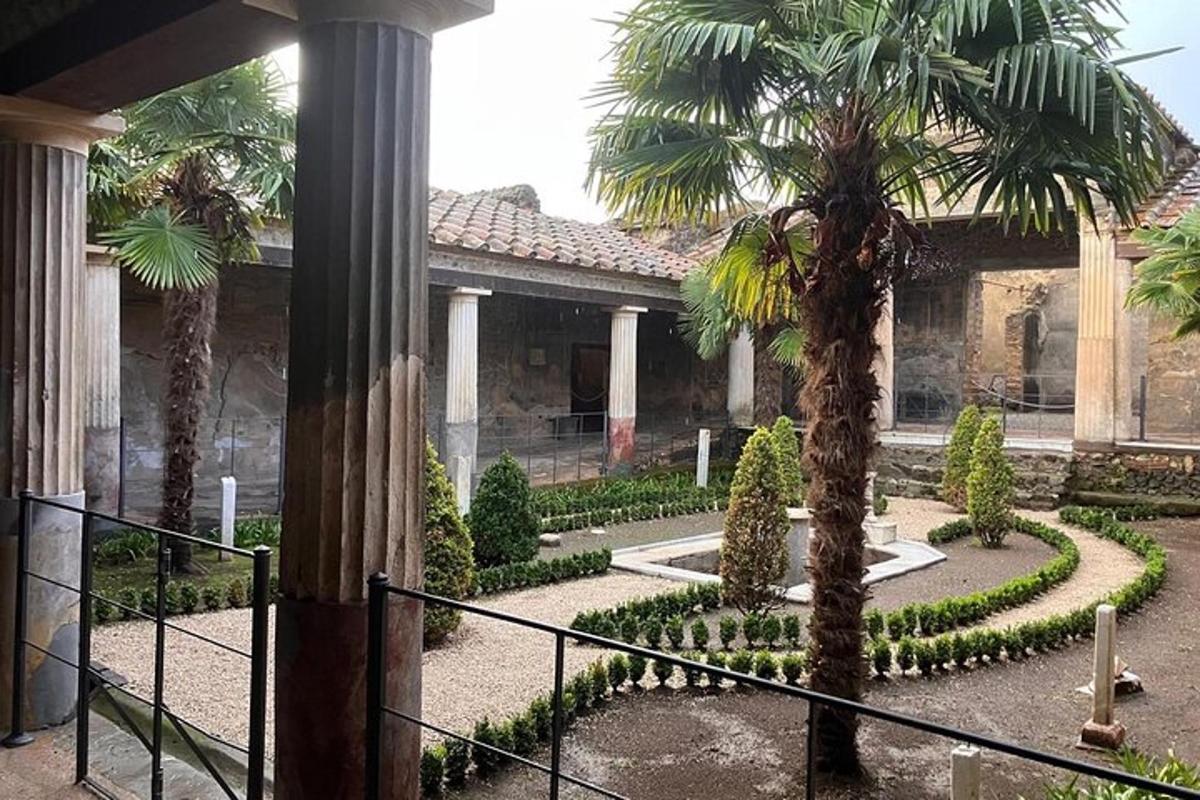 a courtyard with palm trees in front of a building