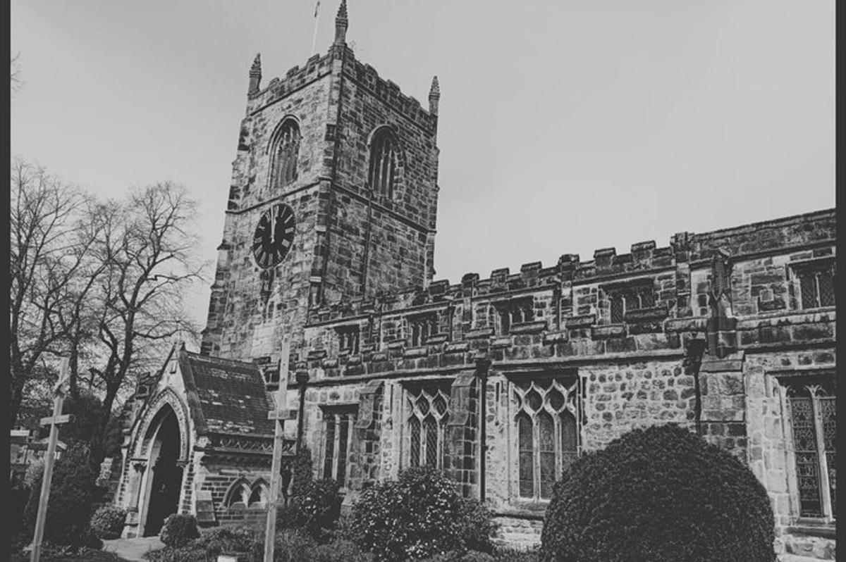a black and white photo of a church with a tower