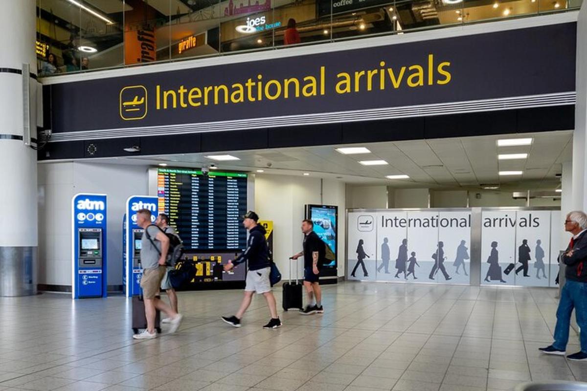 a group of people walking through an international airport