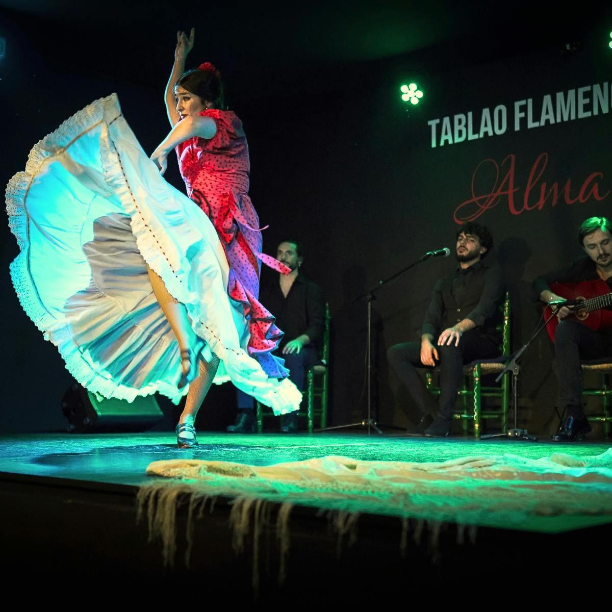 a woman is dancing on a stage with an umbrella