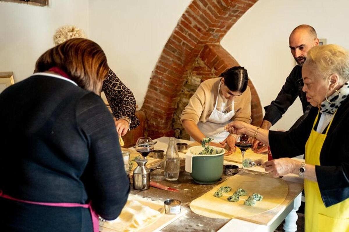 a group of people standing around a table preparing food