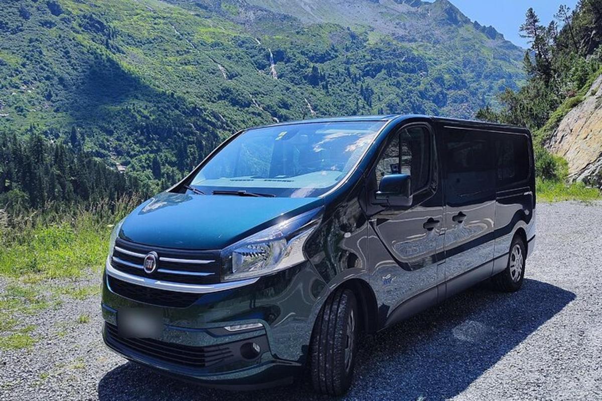 uma van preta estacionada na encosta de uma montanha
