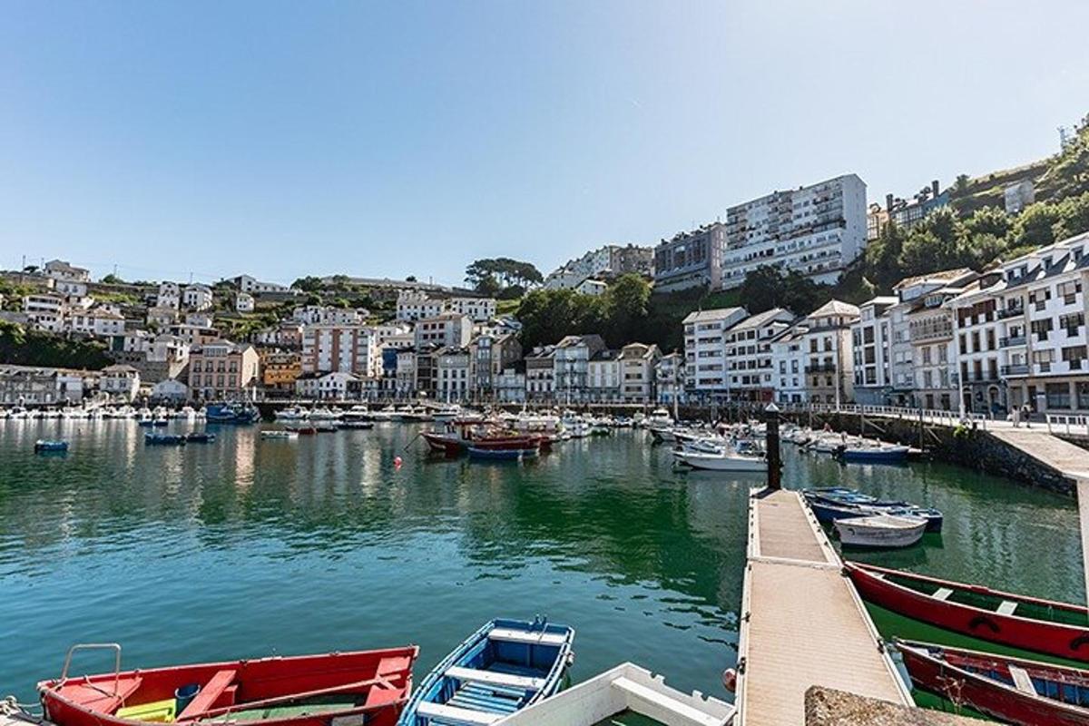 a group of boats docked in a river with buildings