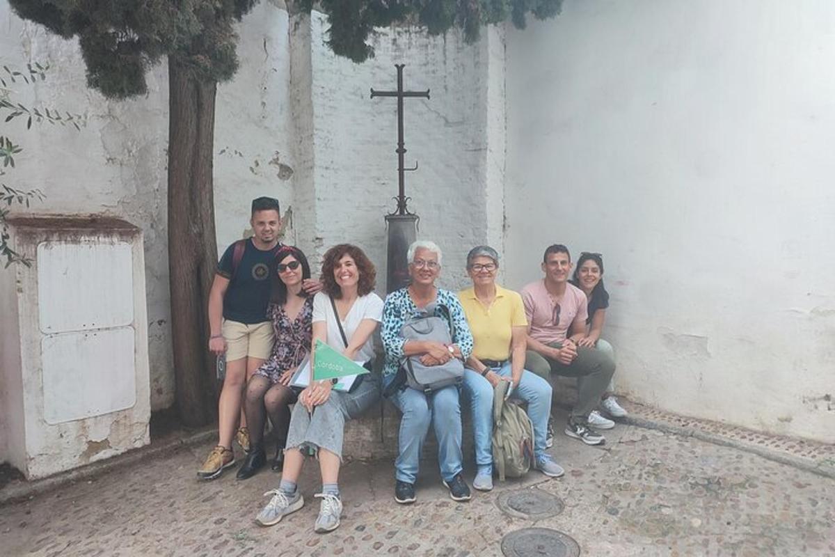 a group of people sitting on a bench in front of a church