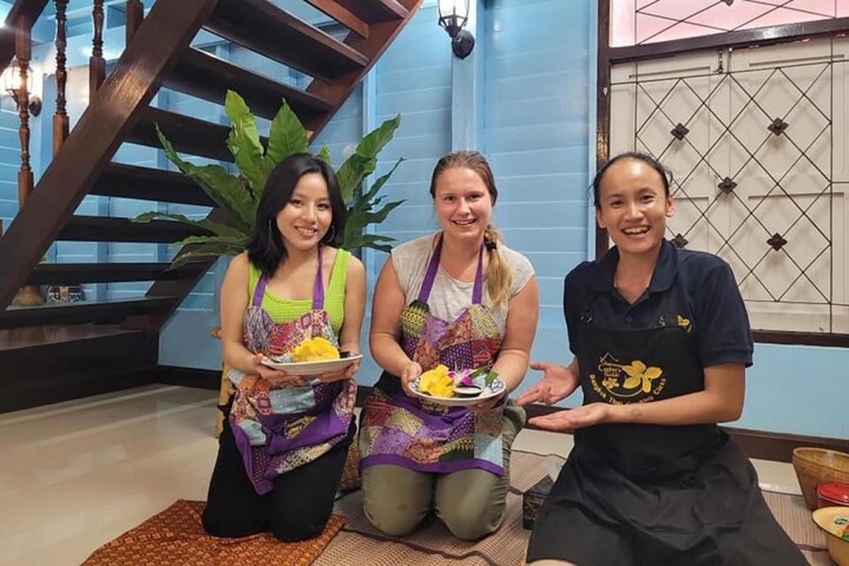a group of three women holding plates of food