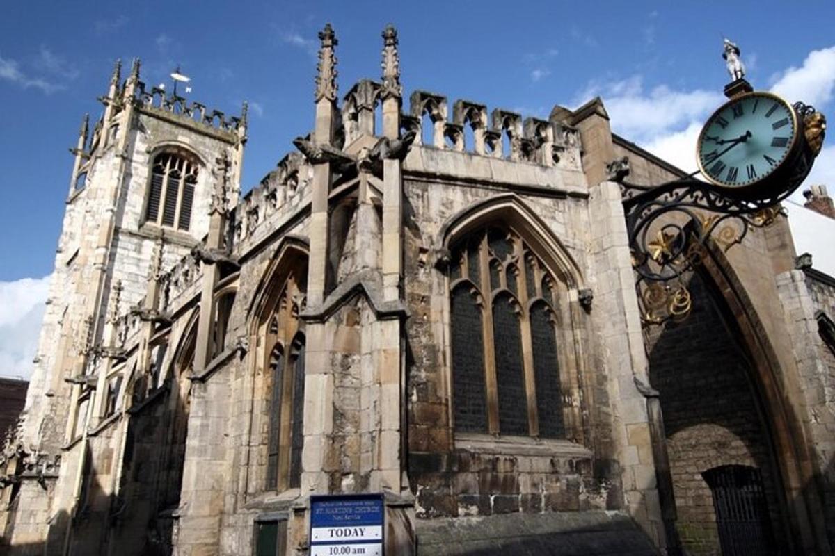 an old church with a clock in front of it