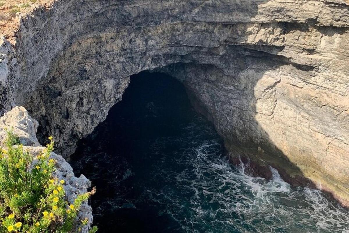 a large rock cave with water in it