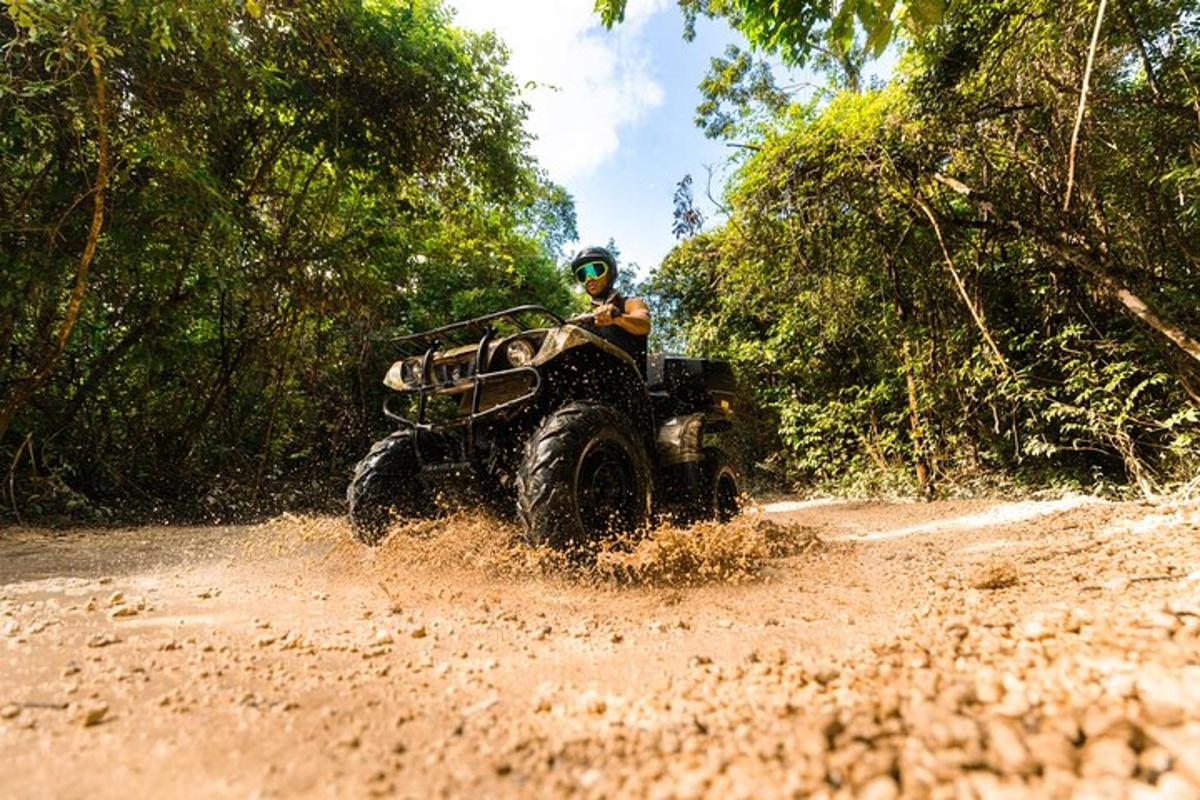 a person riding an atv on a dirt road
