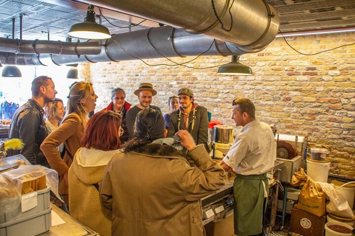 a group of people standing around in a kitchen