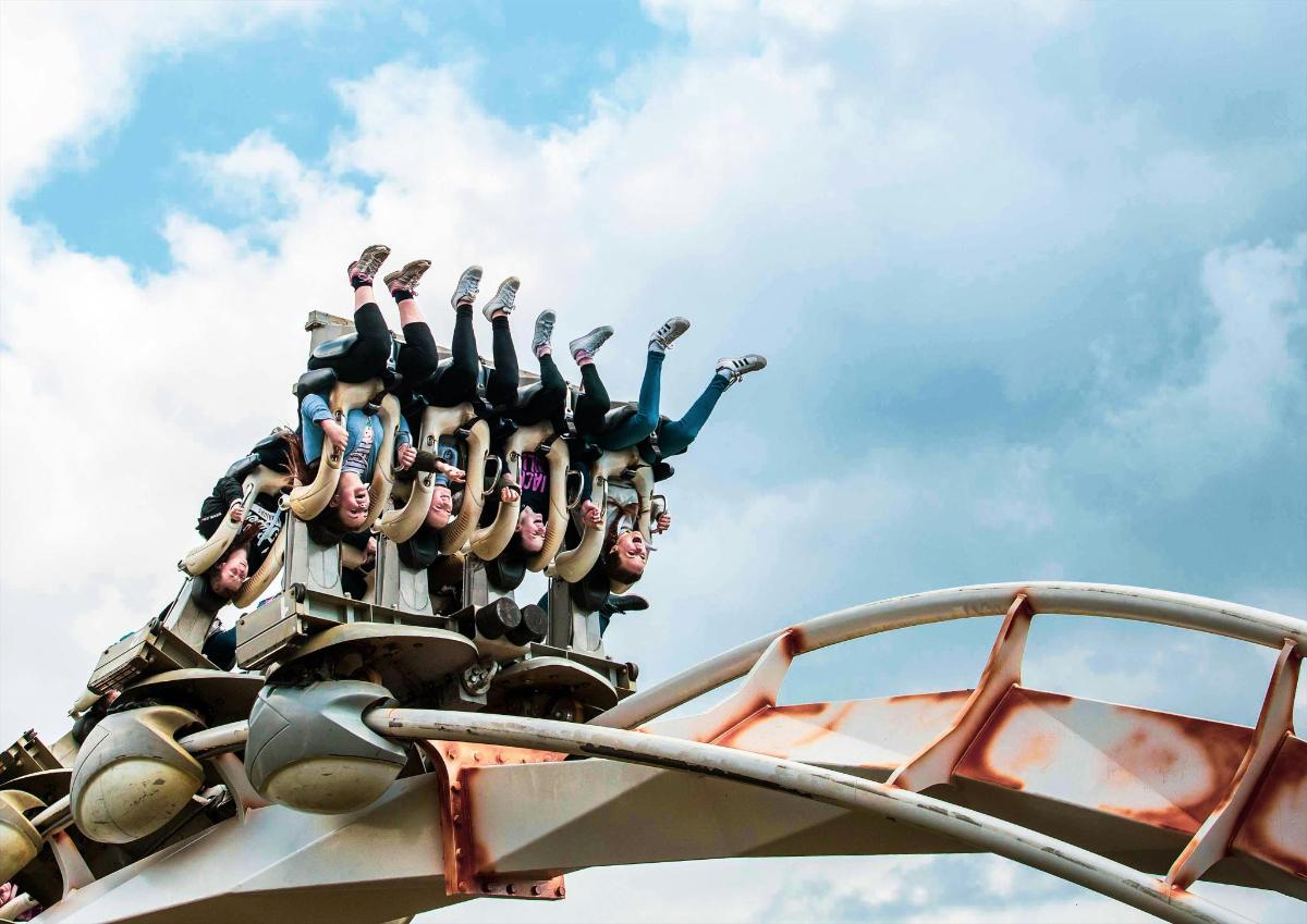 a group of people on top of a roller coaster
