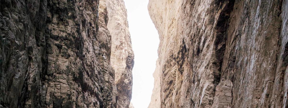a view from the inside of a canyon between two trees