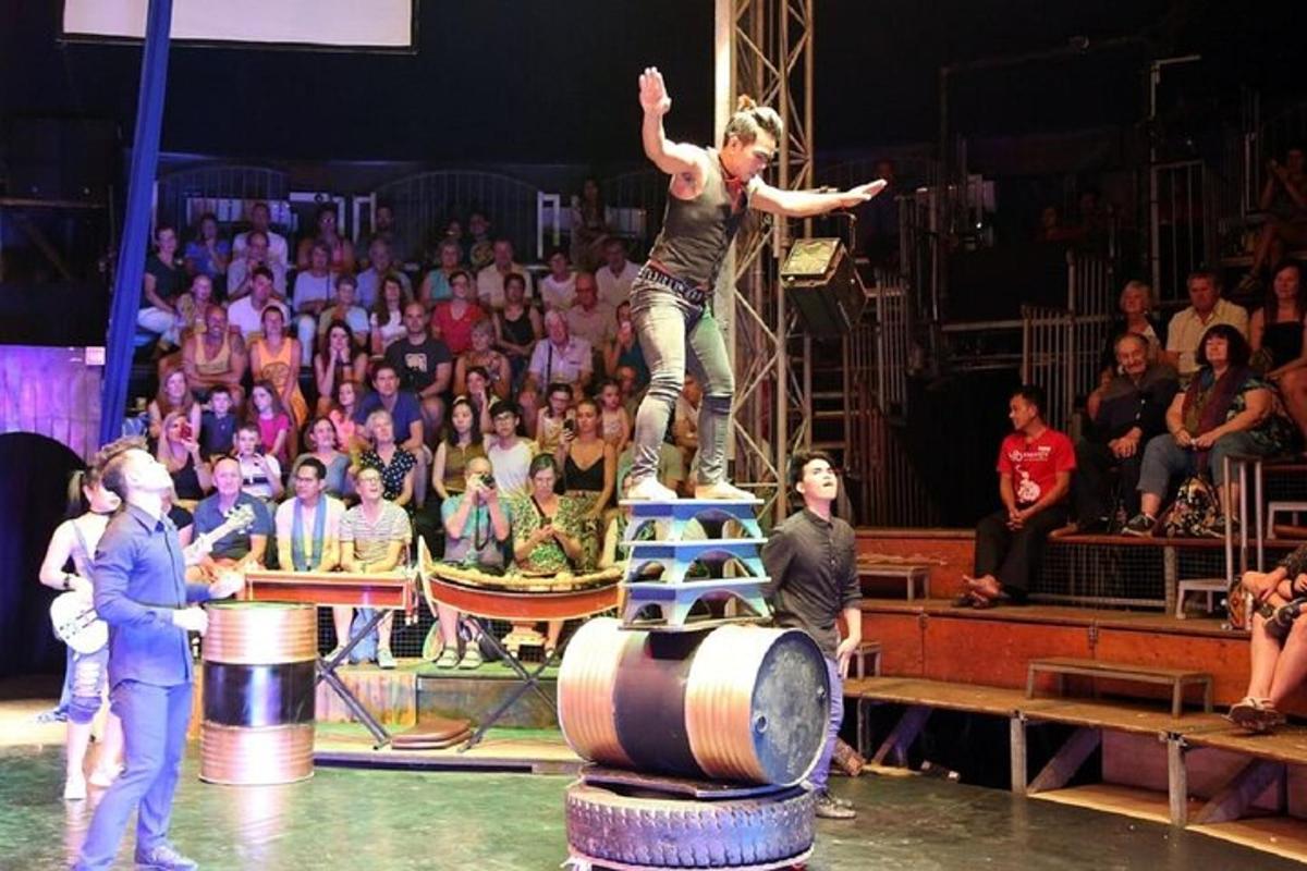 a man jumping off a barrel in front of a crowd